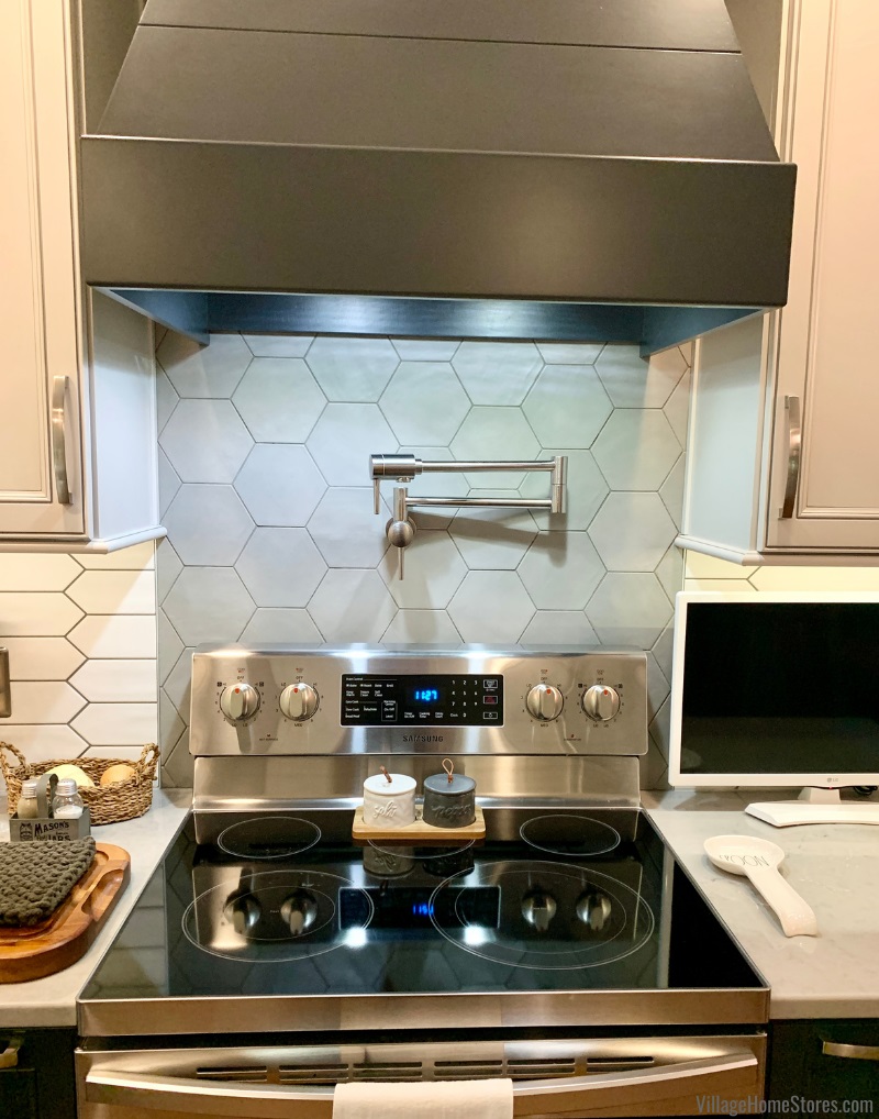 cooktop with gray hex tile accent on wall