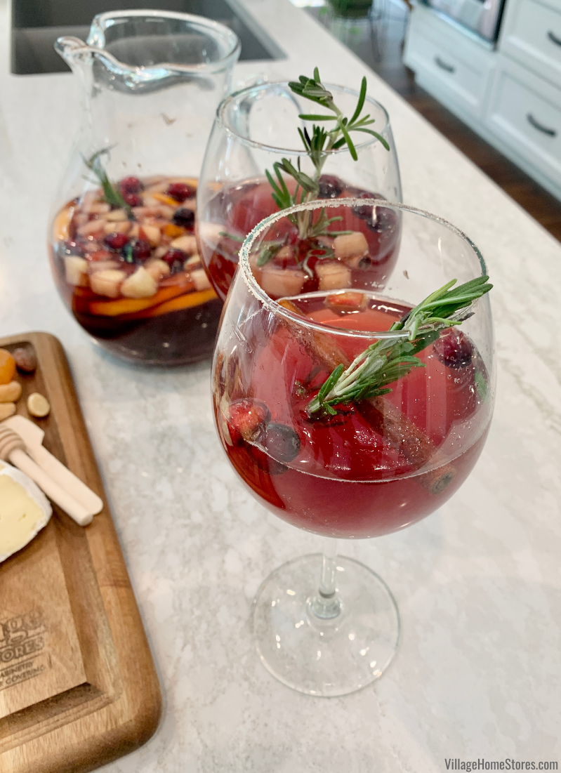Two glasses of festive holiday sangria with rosemary garnish on Ironsbridge Cambria quartz countertops