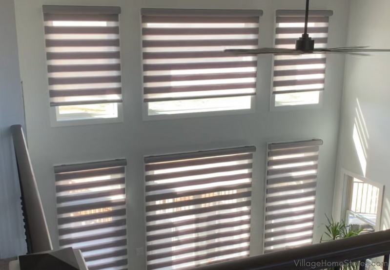 Wall of great room with multiple windows and transitions window shades shown filtering light
