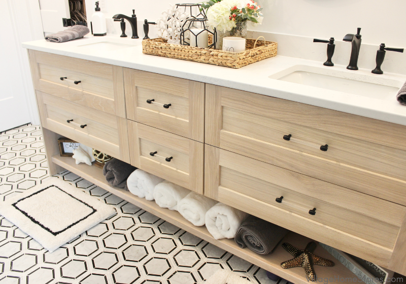 white oak double vanity cabinet with quartz counters and acrylic handle hardware