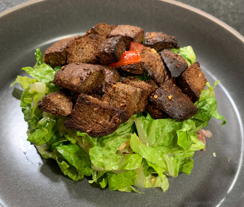 salad on gray dish with homemade bread croutons on top