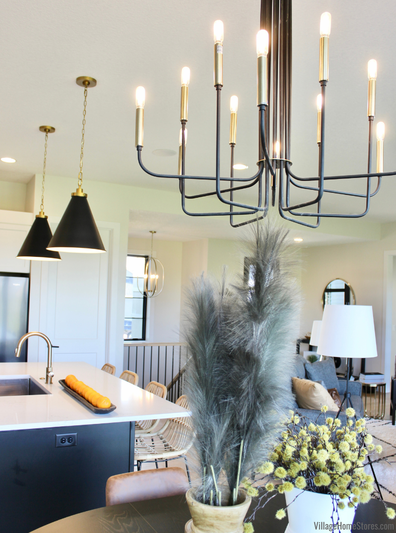 image of black and gold chandelier light and mate black pendant lights in great room kitchen