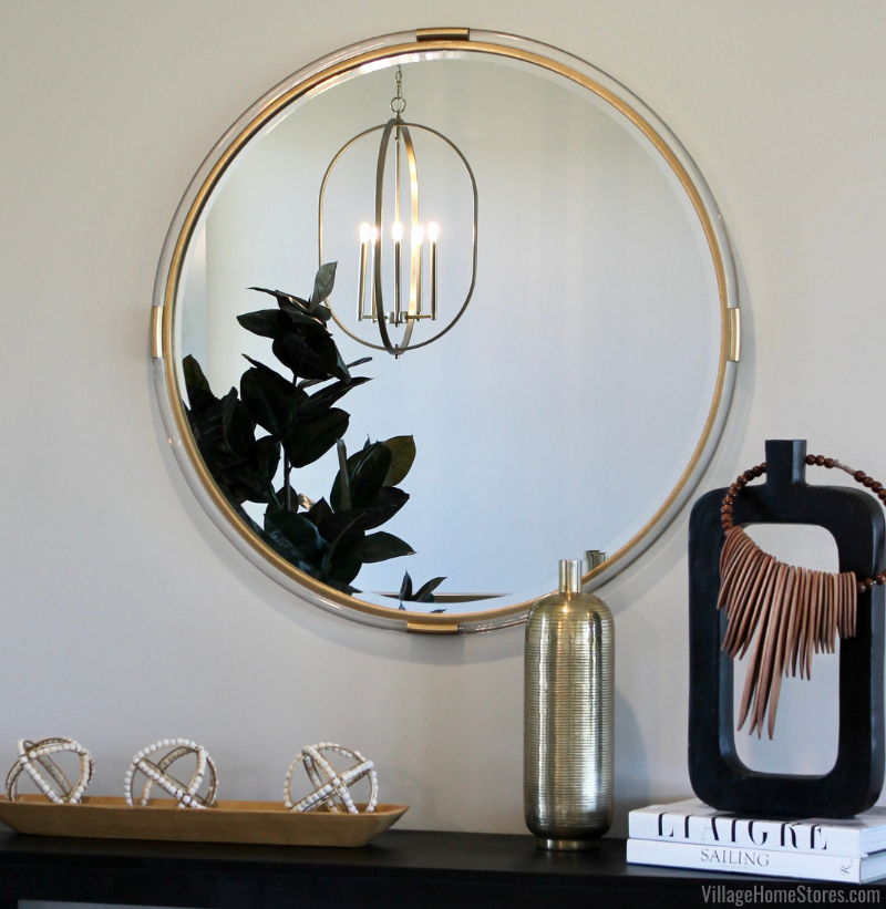 Gold brass foyer light shown in reflection of mirror above styled console table. Lighting by Village Home Stores for Aspen Homes of the Quad Cities.