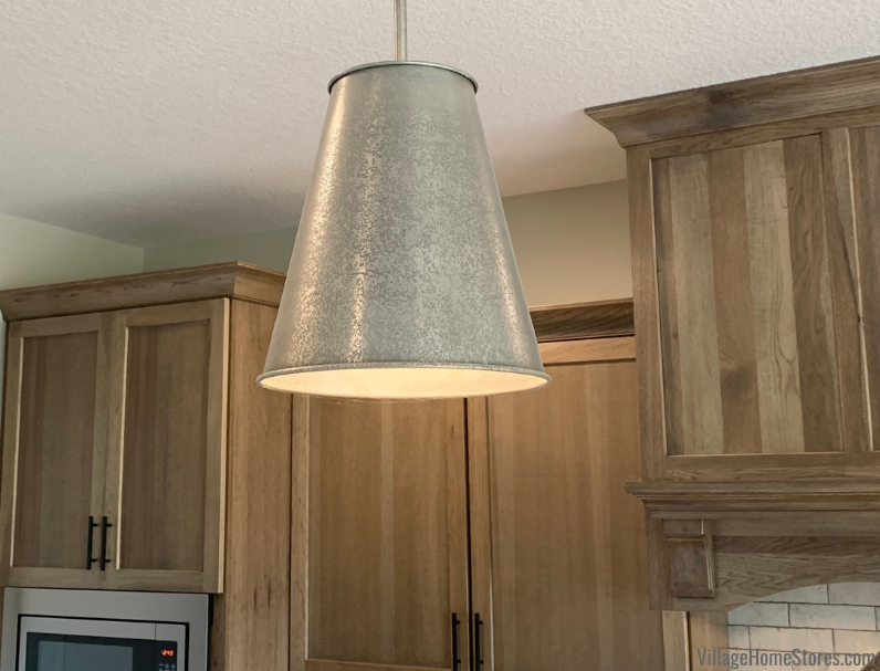 Ari pendant lights in a weathered metal finish. Kitchen lighting by Village Home Stores.