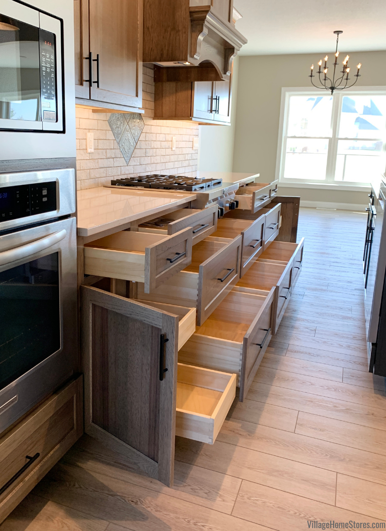 Hickory kitchen cabinet design with all base doors and drawers open showing storage.