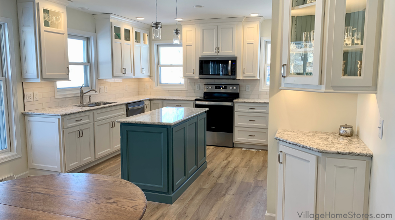 wide shot of u-shaped kitchen design with painted kitchen island at the center 