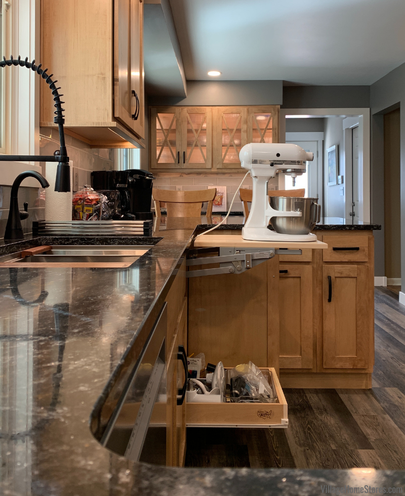 Image of cabinet door open and mixer lift hardware locked in place. Slide out shelf below also shown