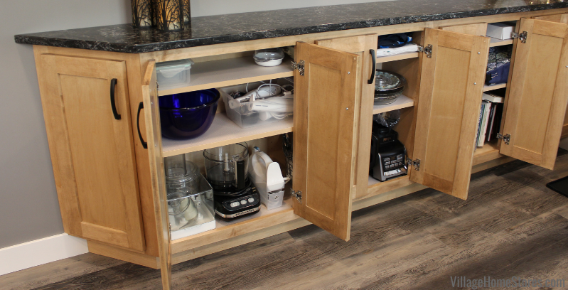 Image of row of shallow full door cabinets installed in kitchen with doors open. Small appliances and mixing bowls inside