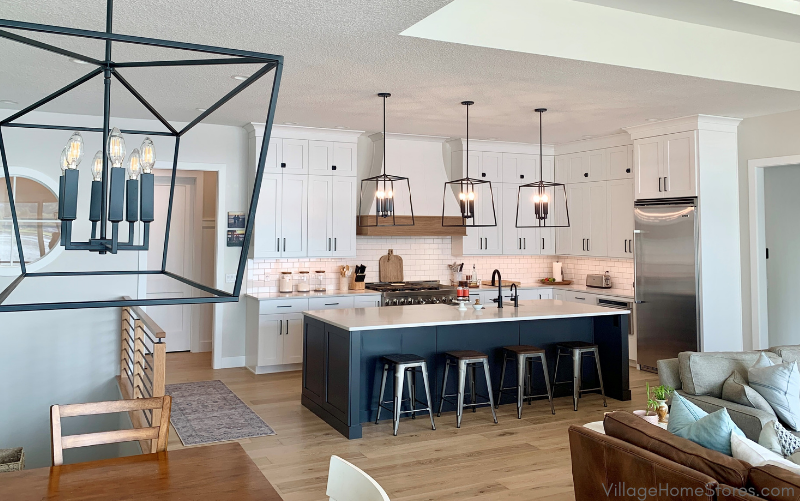 great room kitchen with matte black lantern lighting above dining table and large kitchen island