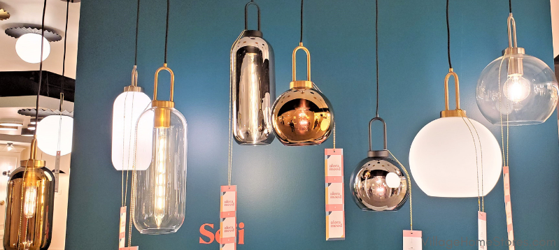 teal painted wall with midcentury modern lantern shaped pendant lighting hanging
