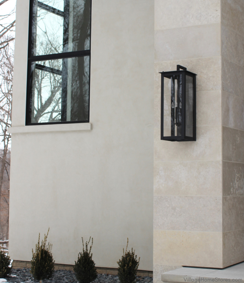 home exterior with limestone surface and large outdoor lantern lighting