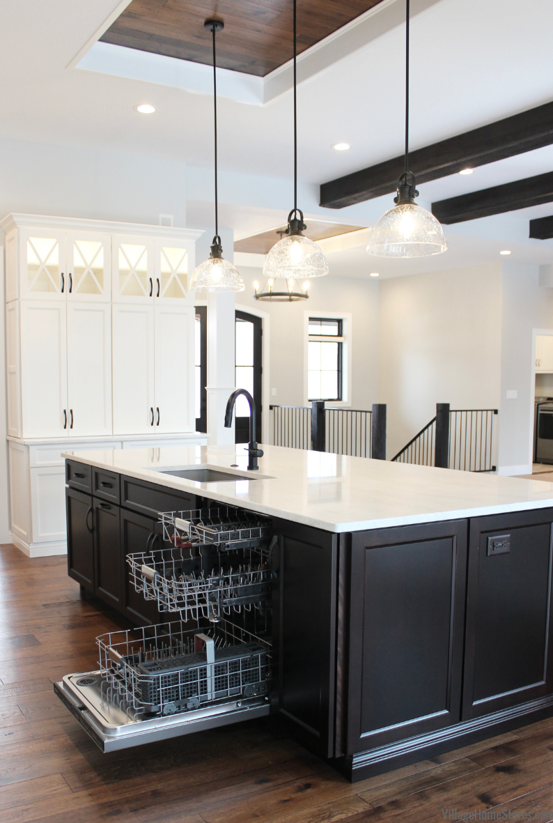 Dark cabinet kitchen island with 3 rack Kitchen Aid dishwasher and Cambria Quartz counters.