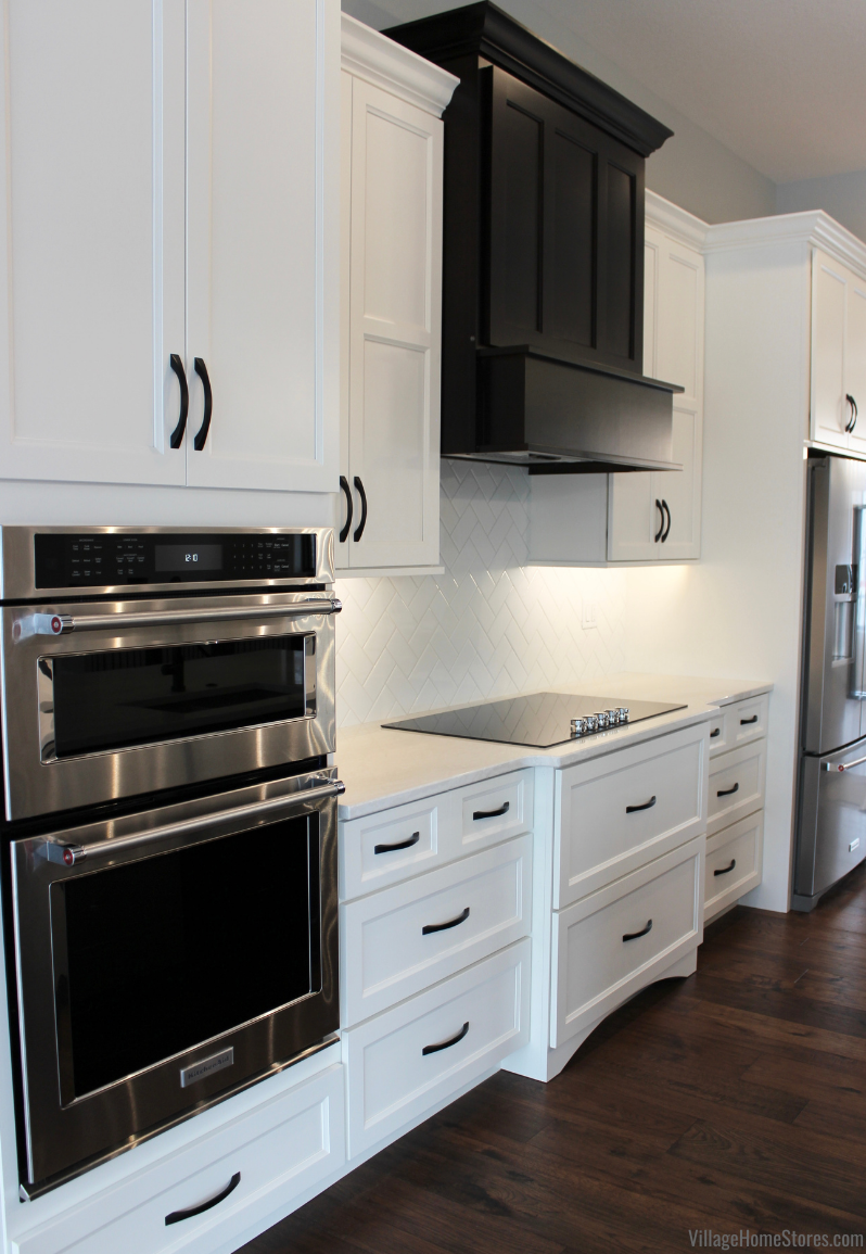 Koch Cabinet kitchen in Ivory Paint with Birch Java wood range hood, KitchenAid appliances, and Cambria Quartz Ironsbridge countertops