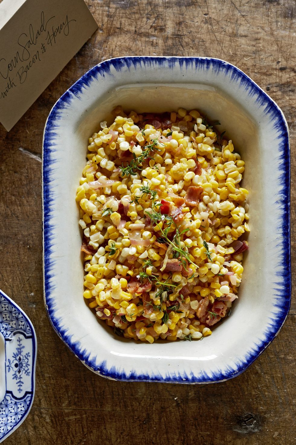 Overhead shot of casserole with corn, bacon, thyme, and honey