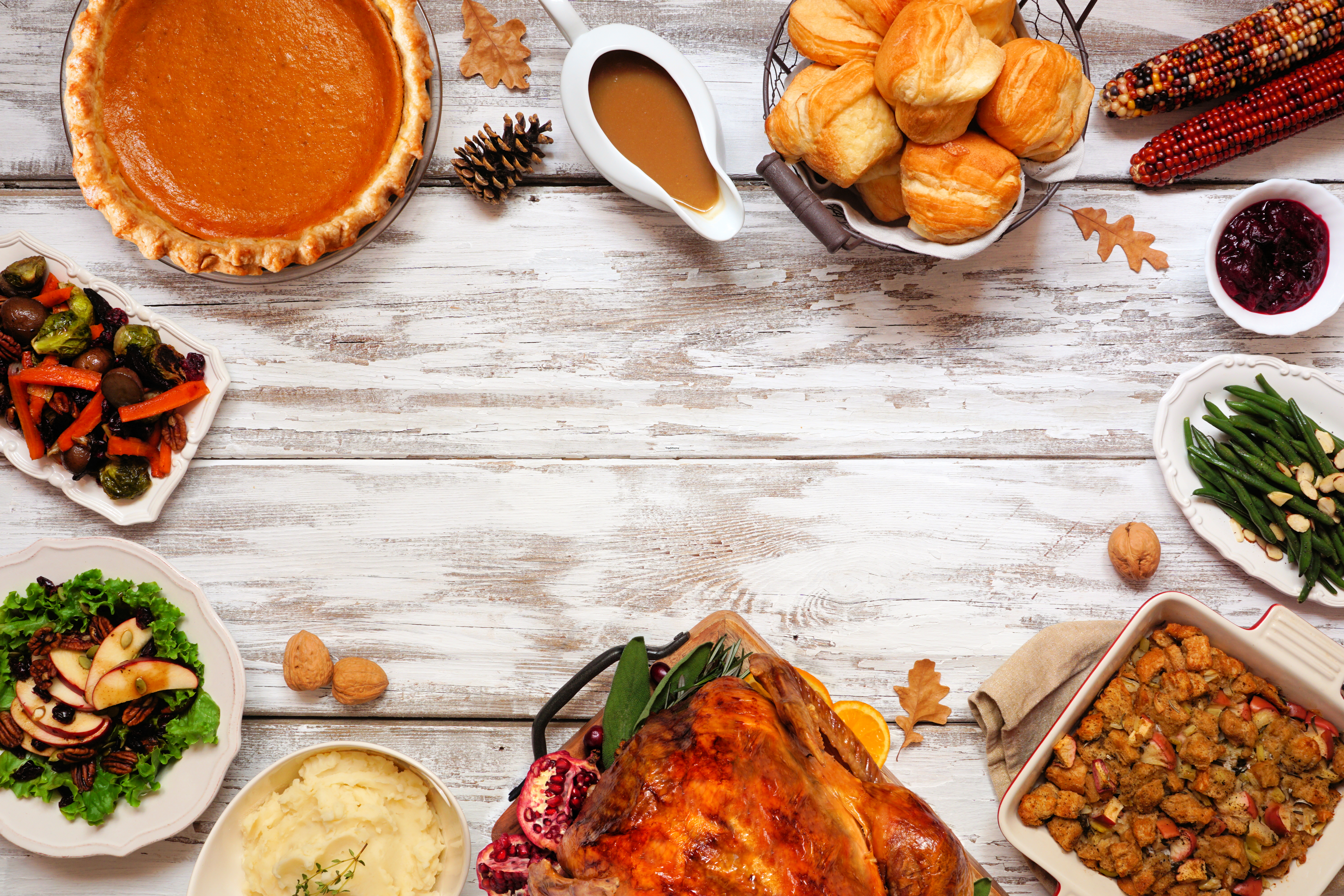 Various Thanksgiving dishes are shown on a table