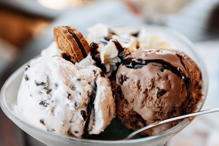 Ice cream sundae with chocolate and vanilla ice cream, whipped cream, chocolate sauce.