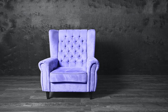 Periwinkle chair with a smoke gray background.