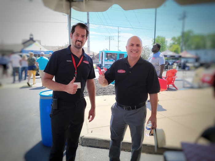Two men standing side by side each other.