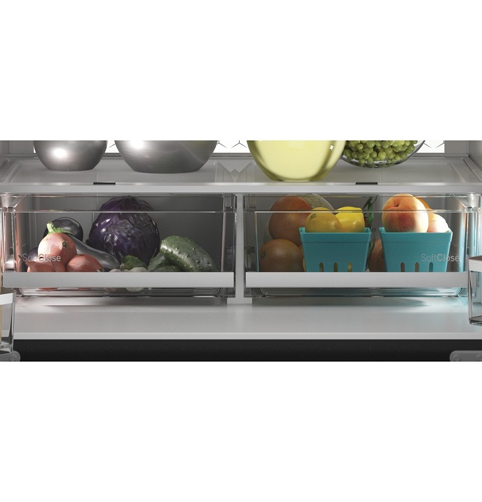 Fruits and vegetables sitting in the crisper drawers of a fridge.