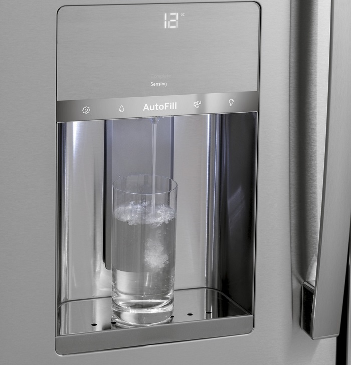 Close up of the water and ice dispenser of a fridge.