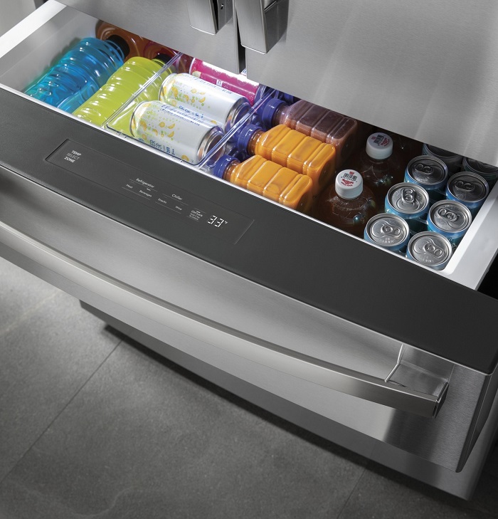 Fridge pull out drawer filled with different beverages.