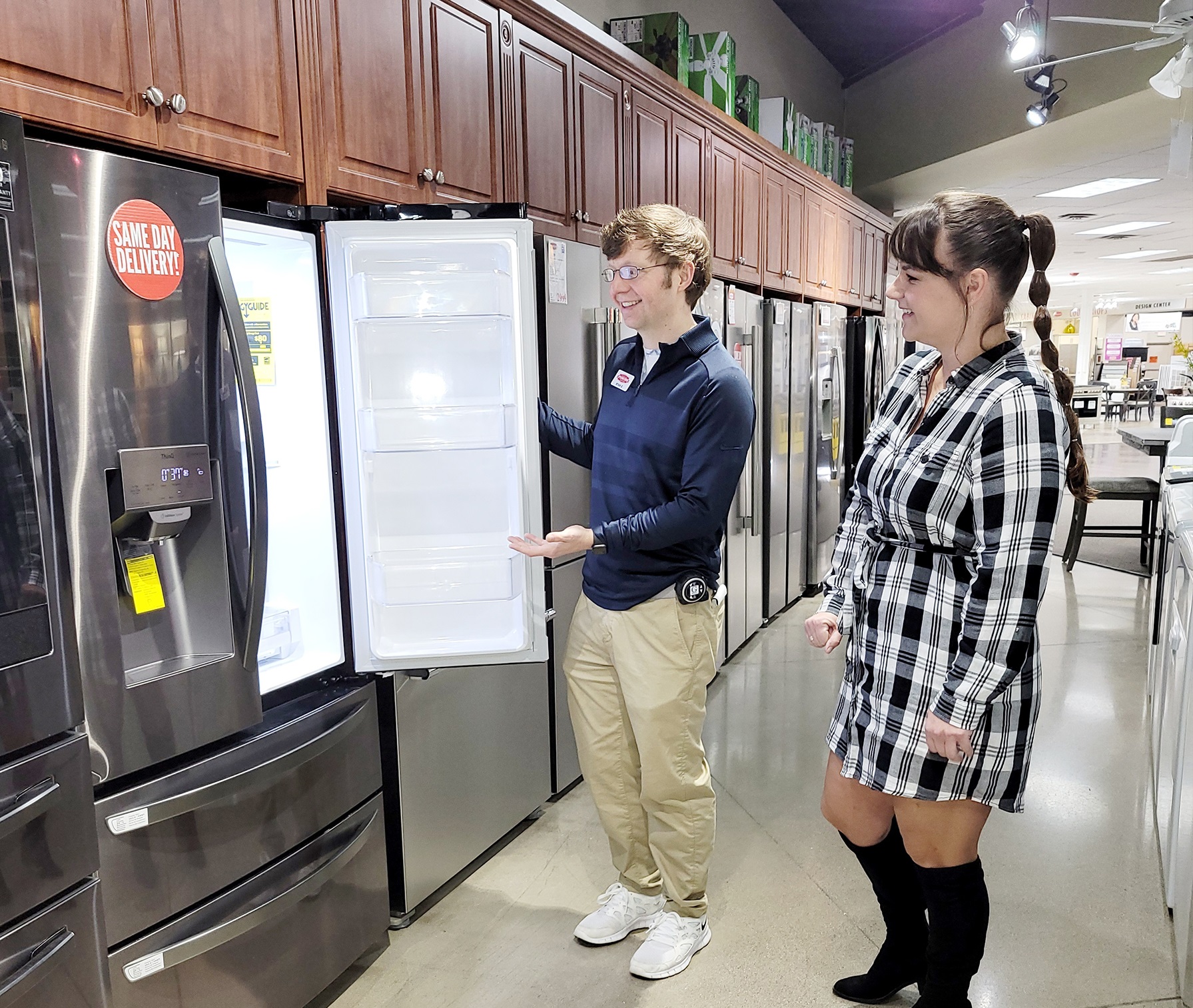 Employee helping customer in an appliance store. 