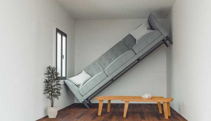 Sofa being stood up diagonally between a space that's too small.  
