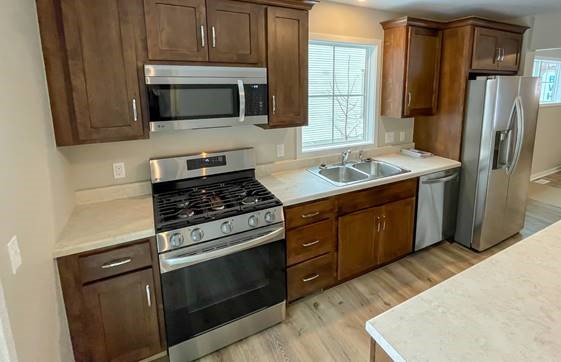 Modern kitchen with stainless steel appliances.