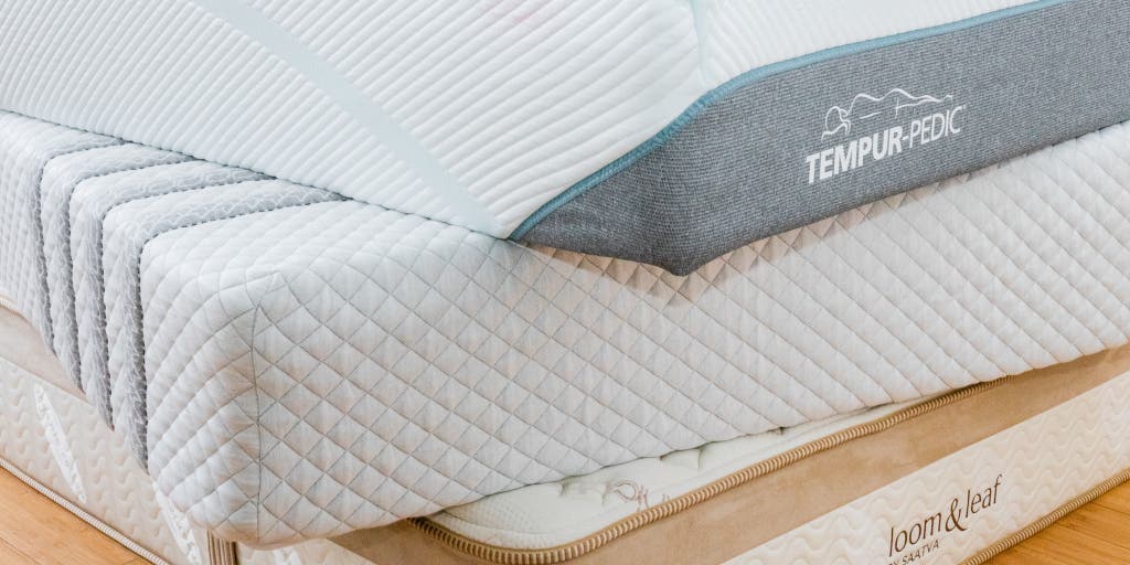 Memory foam mattresses stacked on each other.