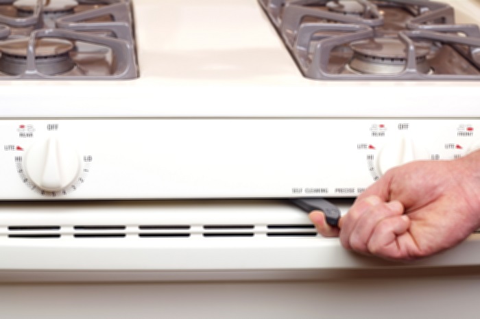 Hand switching on the self cleaning lever on a oven.