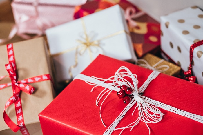 Several Christmas gifts wrapped next to each other. 