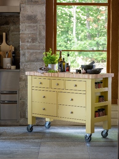 Profile of Canadel mobile kitchen island in yellow finish