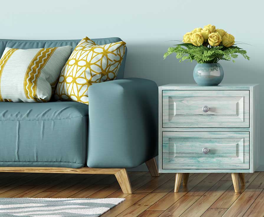 bluish-teal sofa paired with blue side table with white woodgrain finish