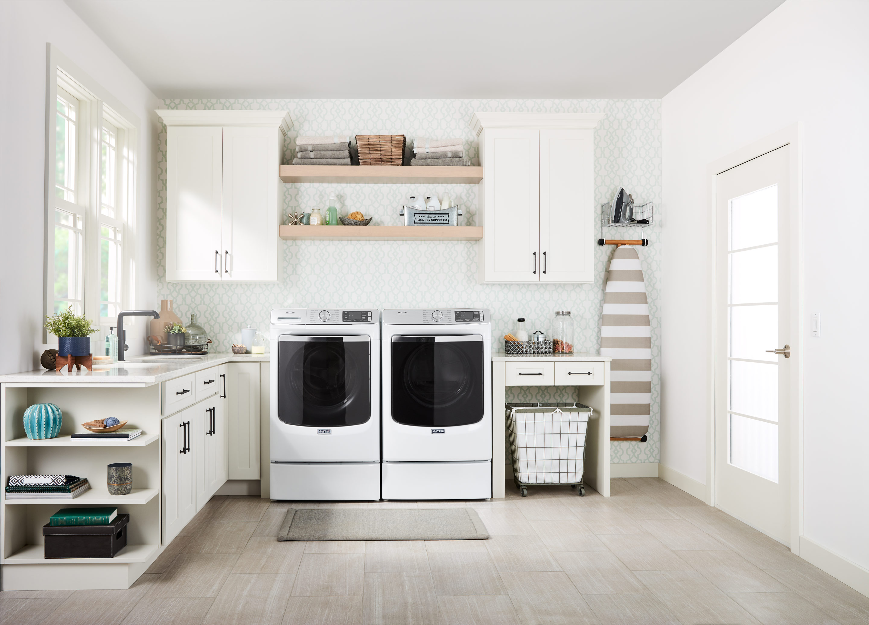 clean, bright laundry room with washer and dryer pair