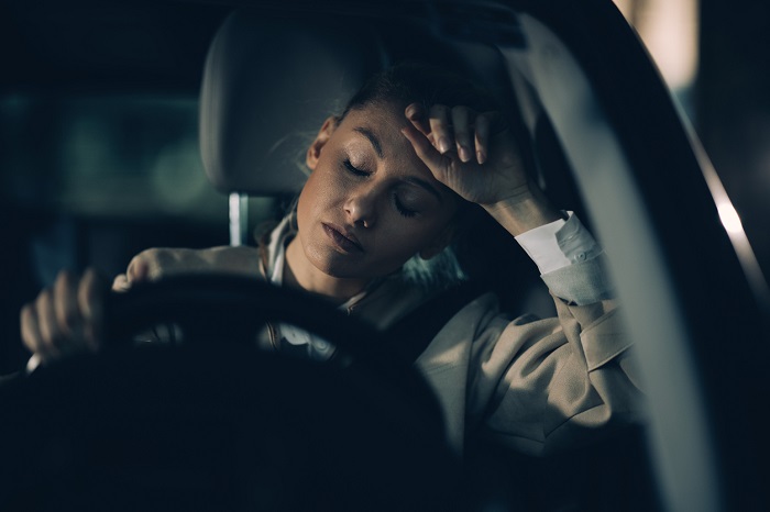 Woman driving at night and tired.