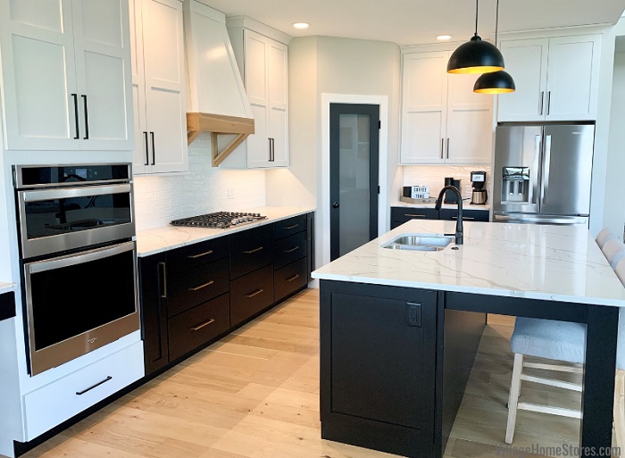 white sleek kitchen with a black dishwasher