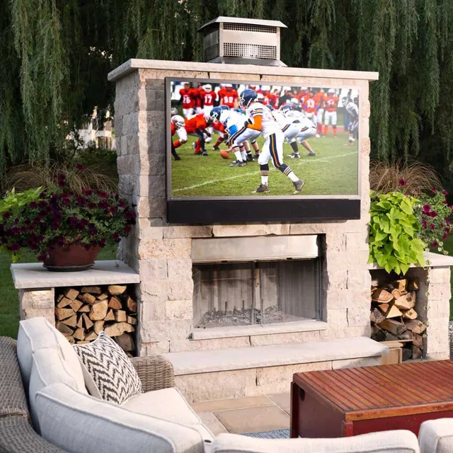 The Seura Full Sun Series TV installed over an outdoor fireplace 