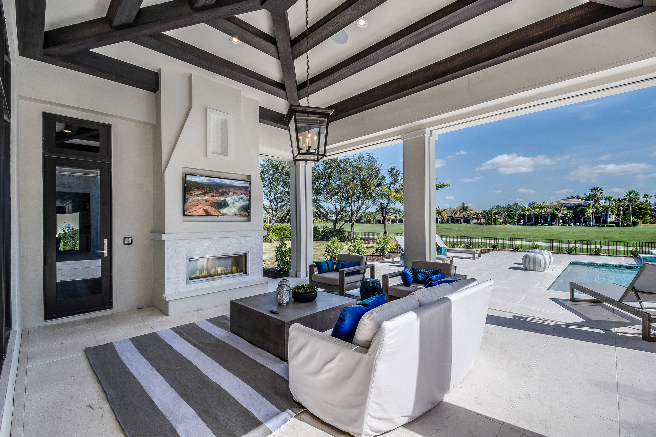 An outdoor entertainment area with an outdoor TV 