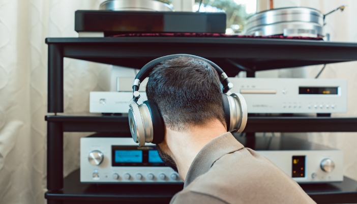 Man tuning his audio equipment setup