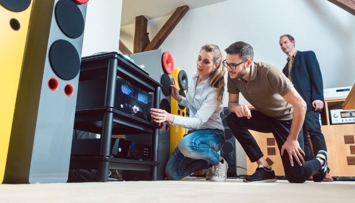 Couple shopping for high-end stereo equipment