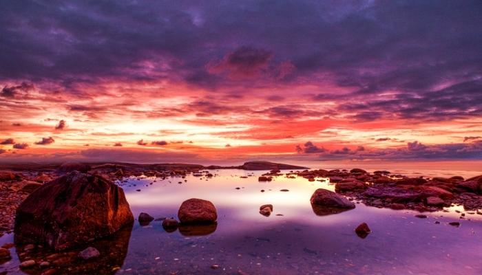 vivid picture of a sunset over water 