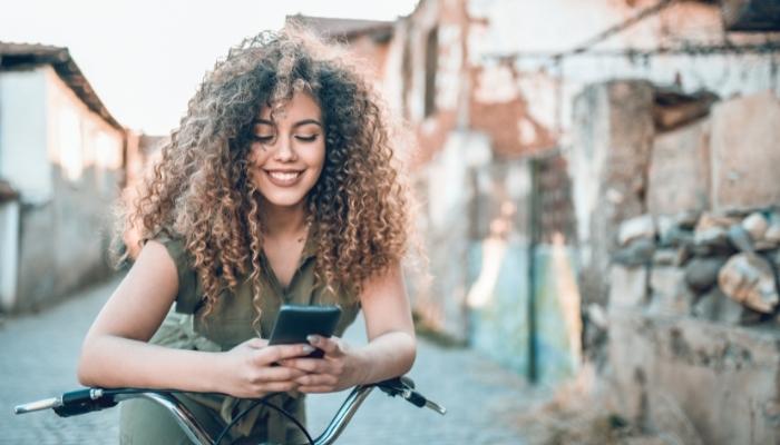 Woman smiling at something on her phone
