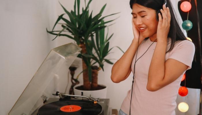 Woman enjoying listening to vinyl
