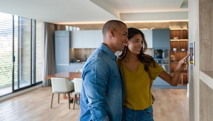 couple using home automation touch pad 