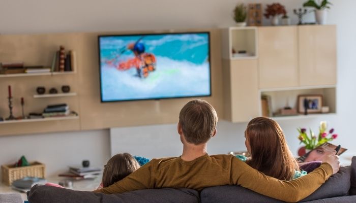 family on couch watching TV