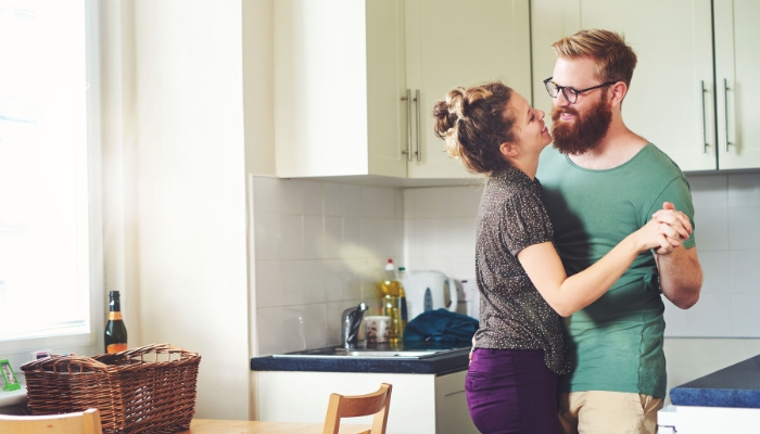 Couple dancing to music through playlist