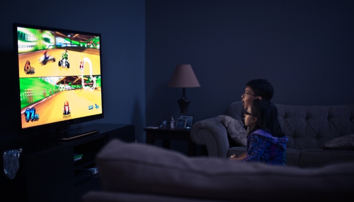  Two kids playing Mario Kart