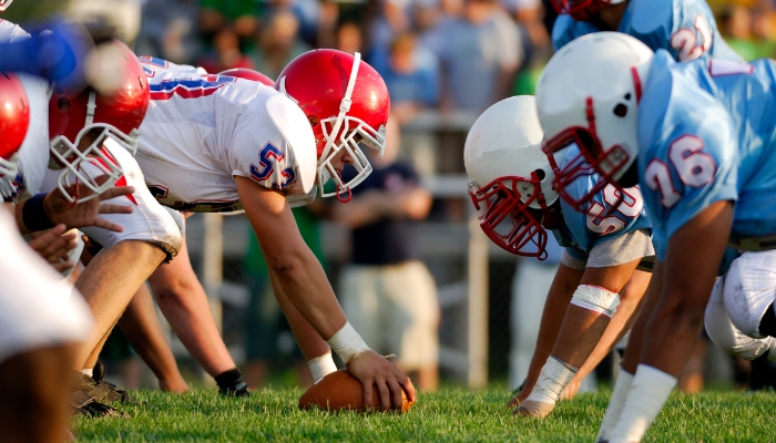 Clear resolution picture of two football teams at the start line