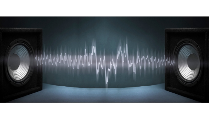 Two speakers with waves coming from both, indicating possible interference