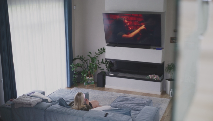 woman watching movie on a tilted tv that is mounted